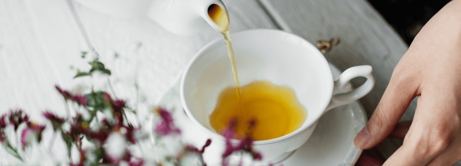 Tea being poured into a teacup in The Hive – Stow-on-the-Wold