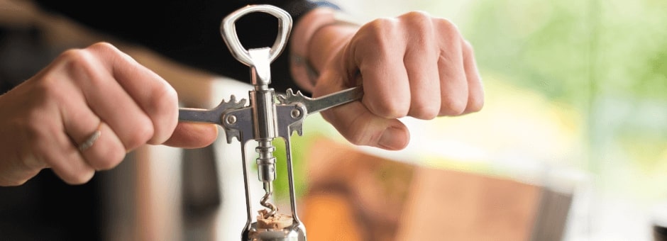 Cork screw opening bottle of wine in The Potting Shed Crudwell