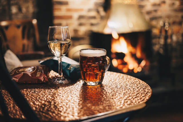 beer, nuts and peanuts on table in pub