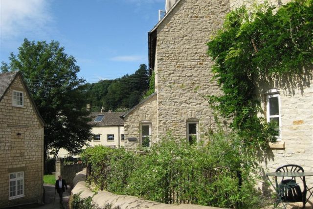 Beautiful stone cottage along road