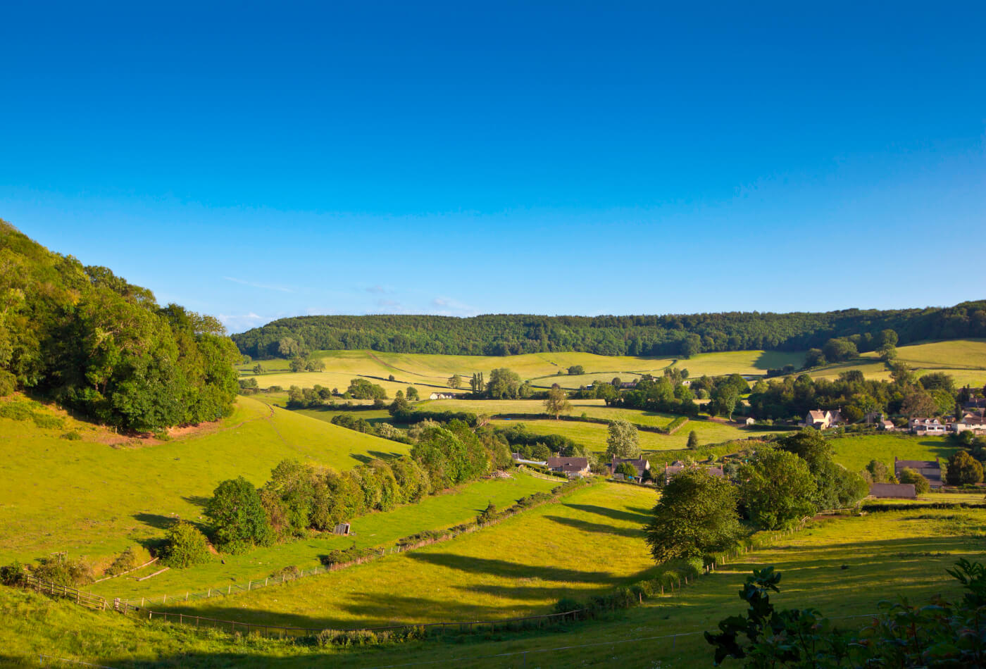 Cotswolds fields on a sunny day with blue sky in background