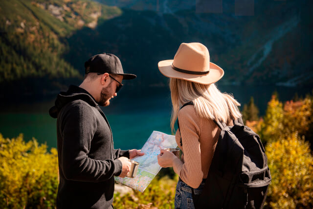 Young couple on a hiking path with a map