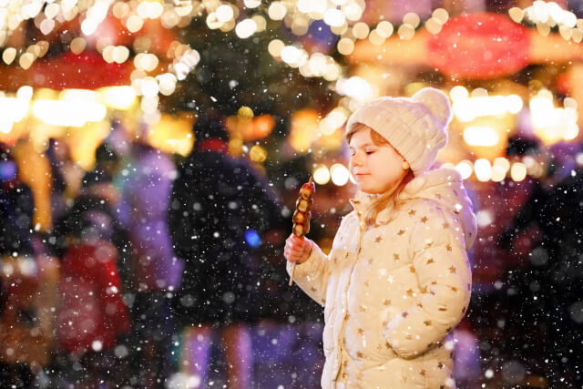 Child eating at Christmas Market in Gloucestershire 