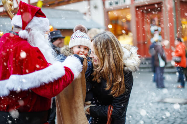 Little girl meeting Father Christmas at Christmas market