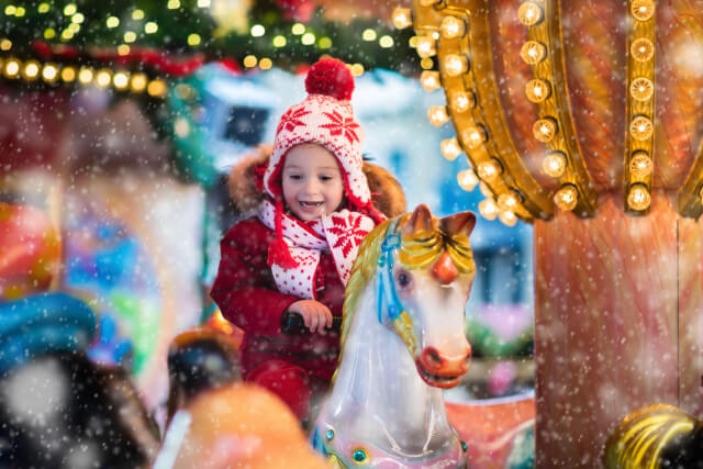 Young boy on carousel horse