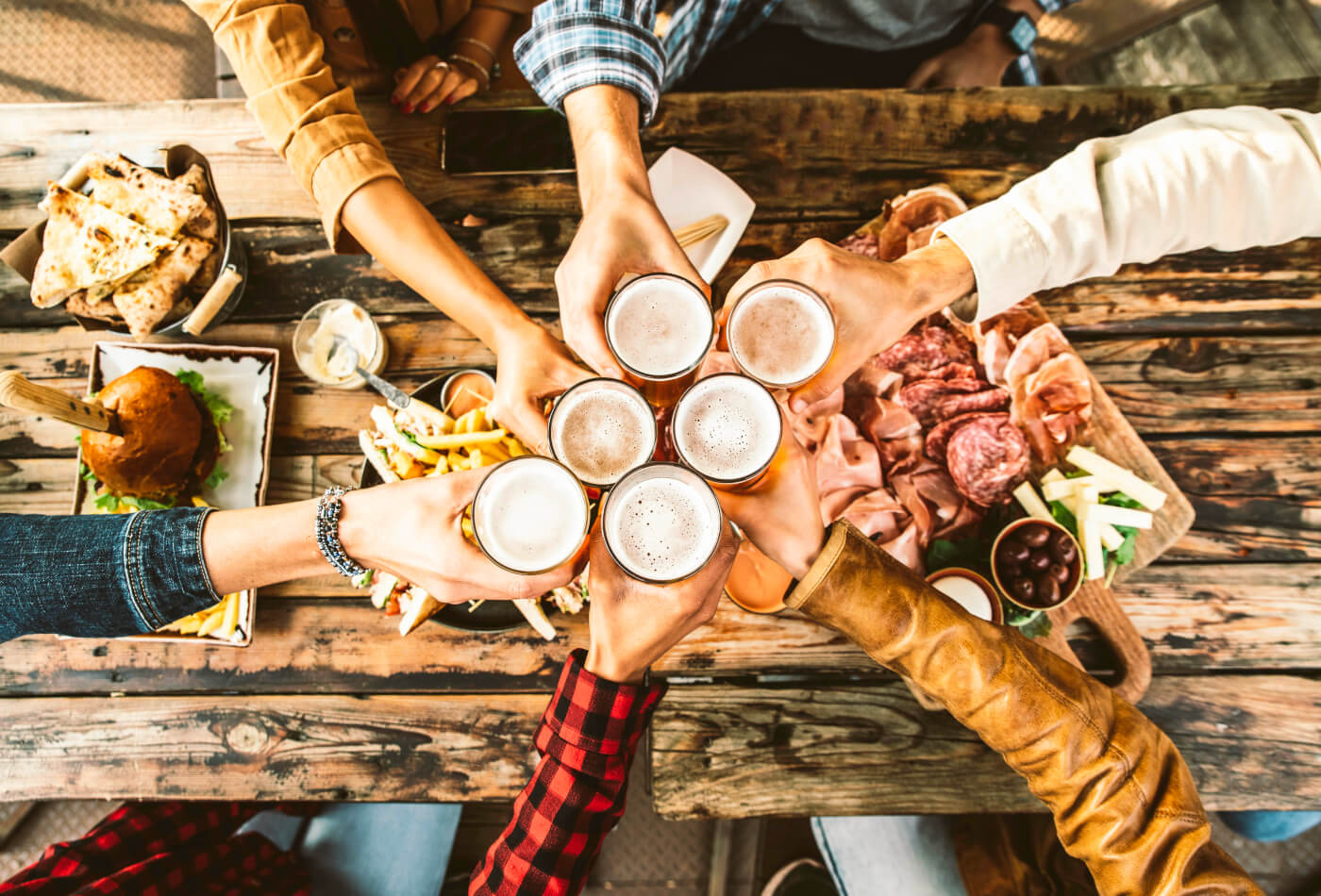 Friends doing a cheers with beer