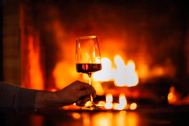 glass of wine with fire in background at Broadway pub 