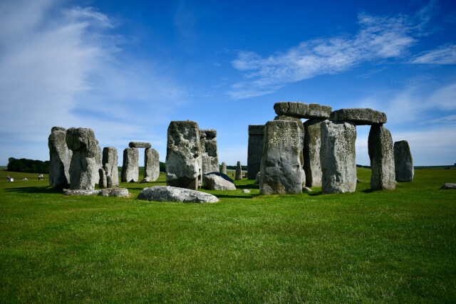 Green grass and blue sky surrounding Stonehenge