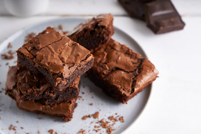 Chocolate brownies on white plate